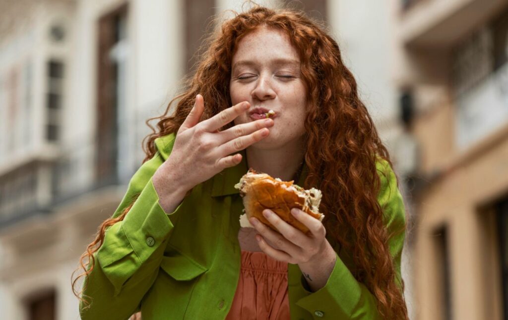 beautiful_woman_eating_delicious_street_food_outdoors_0ef865c7865aba39cd1c16d21027c069_1300x820