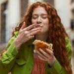 beautiful_woman_eating_delicious_street_food_outdoors_0ef865c7865aba39cd1c16d21027c069_1300x820